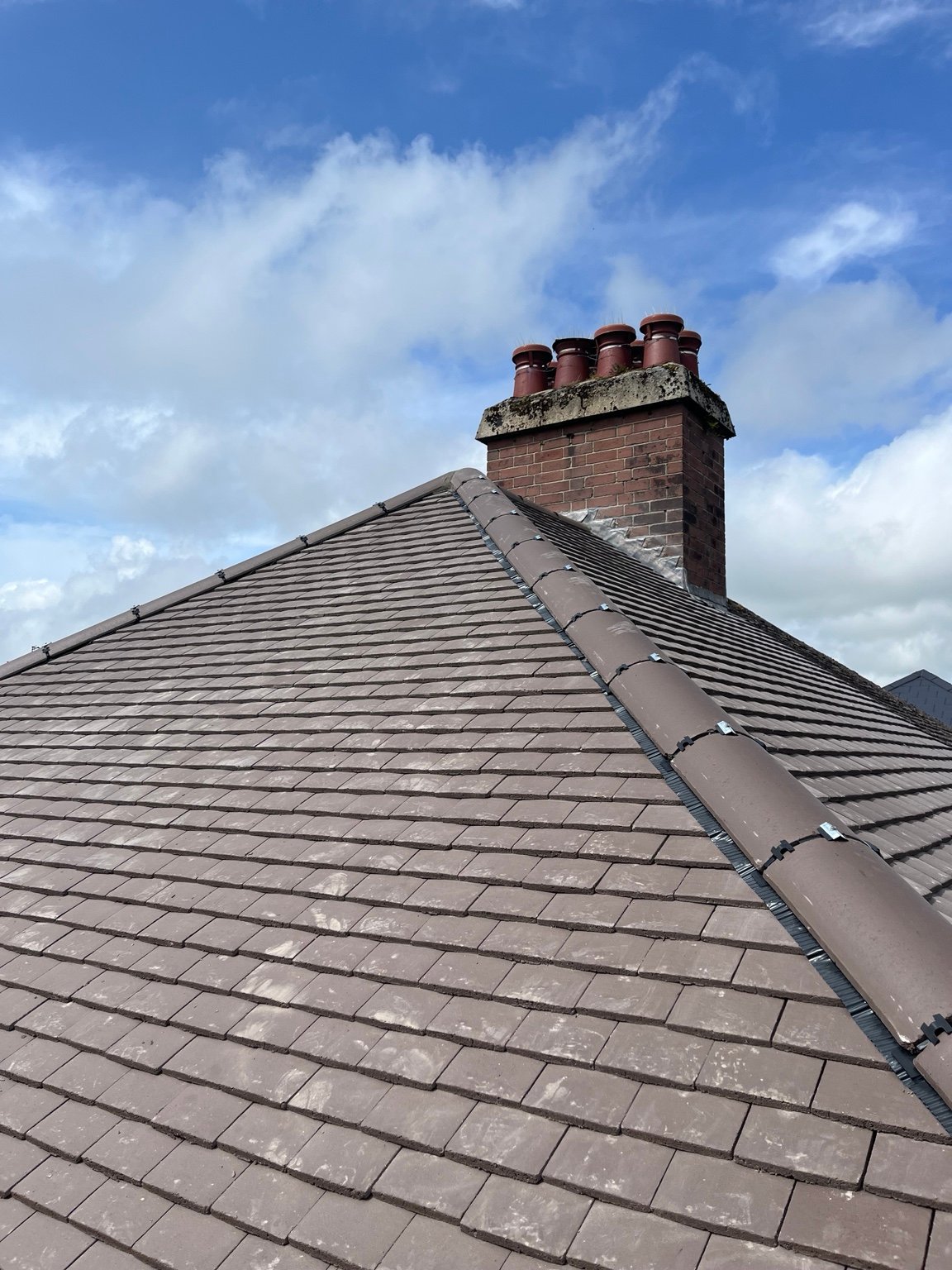 New brown concrete plain tiles being installed