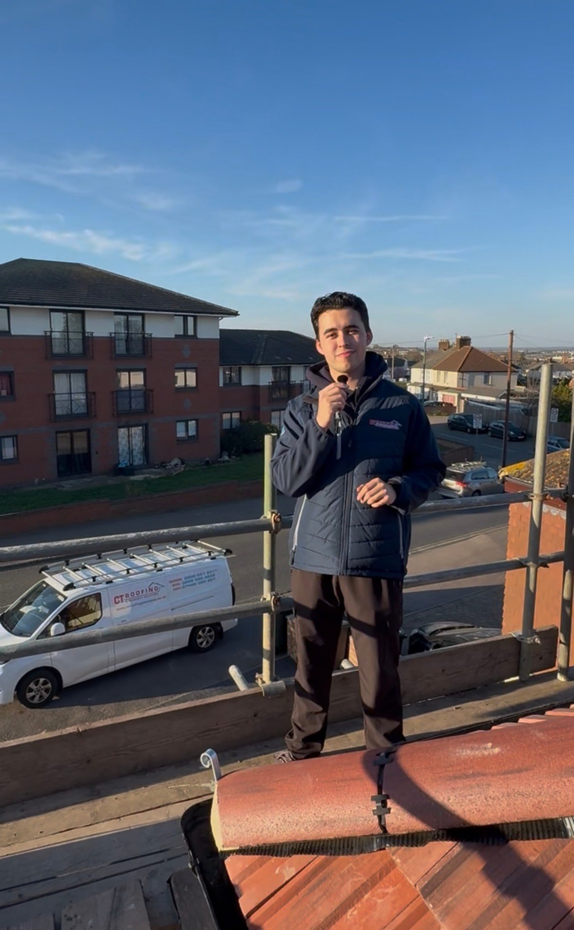 CT Roofing team member on a roofing project with a branded company van